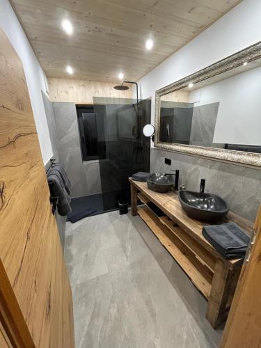 a bathroom with two sinks and a mirror at Saalach Chalet in Lofer