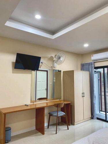a room with a desk and a mirror at Neo cafe and hotel 2