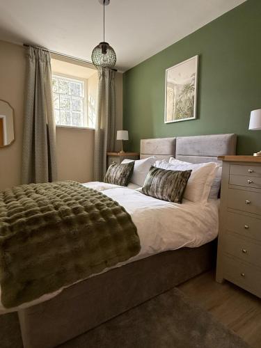 a bedroom with a large bed and a window at Townhouse in Shaftesbury