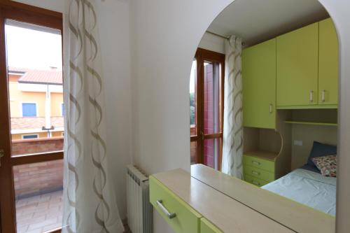 a bedroom with green cabinets and a bed and a window at Residence Sole&Mare in Rosapineta