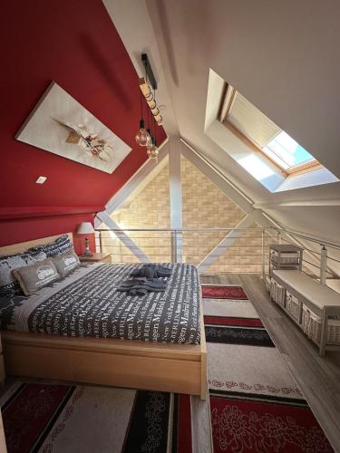 a bedroom with a bed with a red ceiling at The2 Work or holiday apartment in Godshuis