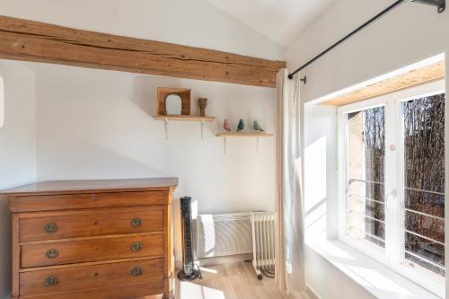 a room with a wooden dresser and a window at On dirait le Sud - Proche Mâcon SOLEIDOR in Mâcon