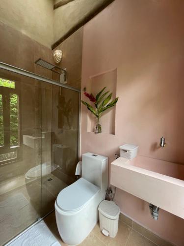 a bathroom with a toilet and a shower and a sink at MAHAGUA Casa Holística - Jambreiro, Caraiva, BA in Porto Seguro
