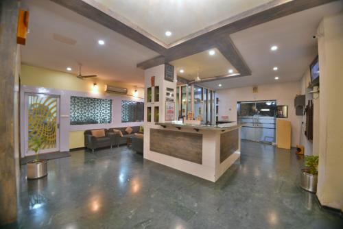a lobby with a bar in the middle of a room at Hotel Royal Embassy in Bhilwara