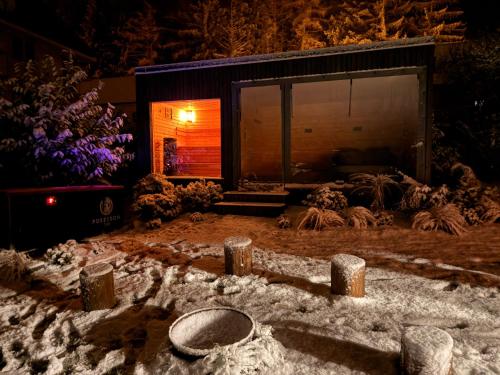 a garden with snow on the ground in front of a building at Chalupa pod Zubštejnem in Bystřice nad Pernštejnem