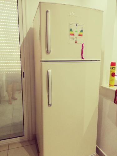 a white refrigerator freezer sitting in a kitchen at Dar-Dhiafa Mayar in Mahdia