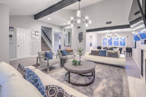 a living room with couches and a table at Sunset Swim, Luxury Vegas Villa with Pool, Hot Tub in Las Vegas