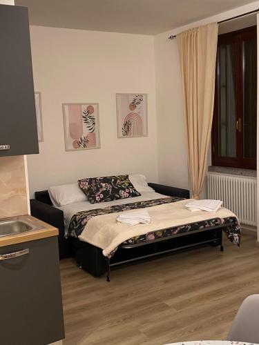 a bedroom with two beds and a window with curtains at Casa MELISSA LIMONCELLA , free parking-self check in in Tavernerio