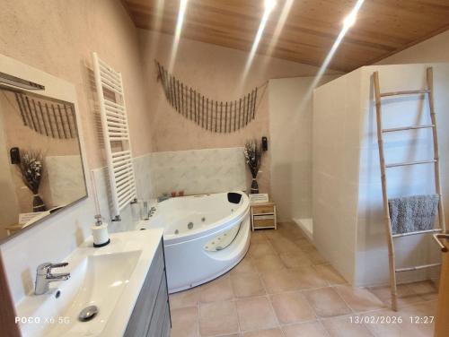 a bathroom with a tub and a sink and a ladder at Casa rural Ca l'Antón in Sant Miquel de Campmajor