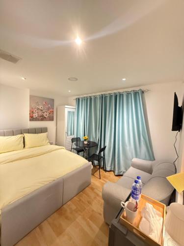 a bedroom with a large white bed and a couch at Grand International in Abu Dhabi