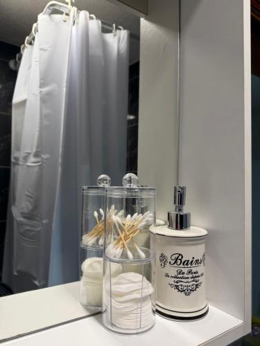 a shelf with a bottle of perfume and a container of towels at Vikendica Rujiste in Mostar