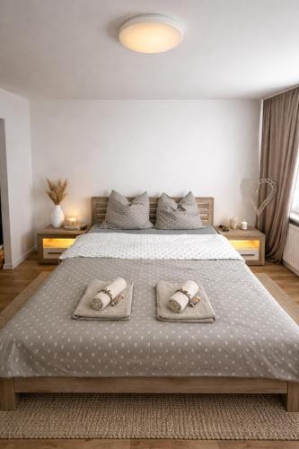 a bedroom with a bed with two towels on it at Modern Central Apartment in Nitra