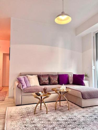 a living room with a couch and two tables at Mor Maison Skopje City-Center FEW FREE PRIVATE PARKING in Skopje