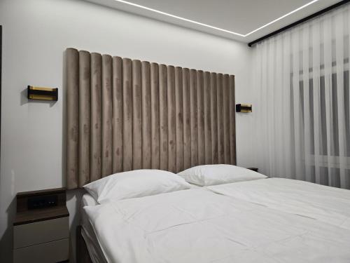 a bedroom with a bed and a large window at Osijek Luxury Center - Self Check-in, 2 Parking Spaces, Balcony, Elevator in Osijek