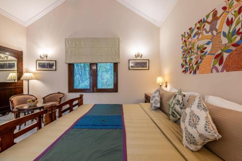 a bedroom with a large bed in a room at juSTa The Bagh, Kanha in Bhīmlāt