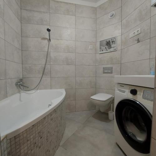 a bathroom with a washing machine and a toilet at Центр,дитяче містечко Казка in Mykolaiv