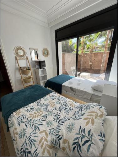 a bedroom with a bed and a large window at VILLA DETENTE PISCINE PRIVEE PROCHE D'AGADlR in Taroudant