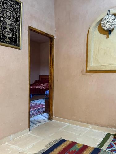 an open door into a room with a bedroom at Bandres farm in Siwa