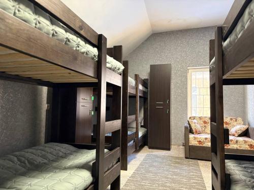a room with four bunk beds and a couch at Хостел Гора in Kharkiv