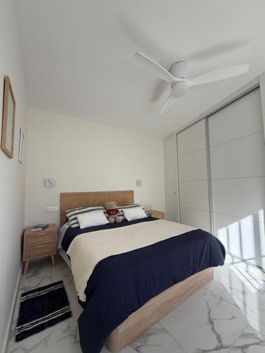 a bedroom with a large bed in a white room at Mi Sitio in Sitio de Calahonda