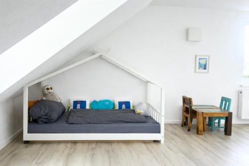 a white bed in a white room with a table at Bali Spirit - Toplage Usingen in Usingen