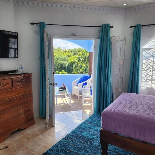 a bedroom with a bed and a sliding glass door at Dr Doc's Family Lodge with Pool in Spur Tree