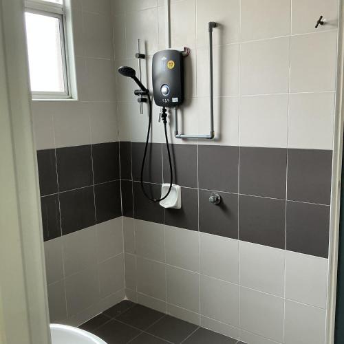 a bathroom with a soap dispenser on the wall at HD DOUBLE-STORY House in Banting