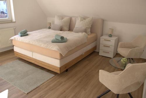 a bedroom with a bed with two towels on it at Ferienhaus Sonnenblick Wernigerode in Wernigerode