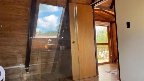 a bathroom with a shower with a glass door at Finca Hotel Mariangel in El Peñol