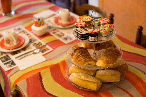 a tray of breads and pastries on a table at Logis hôtel du terreau in Manosque