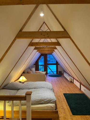a attic bedroom with a bed and a couch at Speicher in Soltau in Soltau