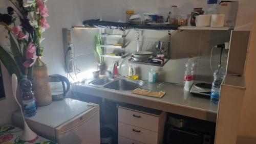a small kitchen with a sink and a refrigerator at Big Room Ashdod in Ashdod