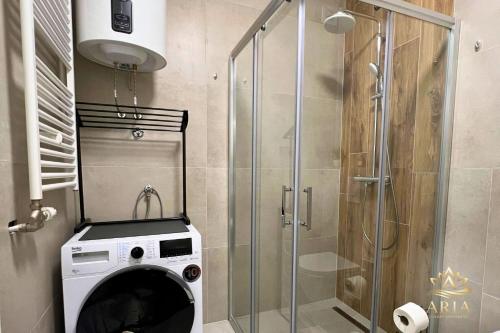 a washing machine in a bathroom with a shower at ARIA Luxury Apartment, Tuzla in Tuzla