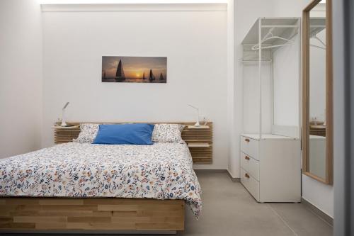 a bedroom with a bed and a mirror at Ad un passo dal mare apartment in Molfetta