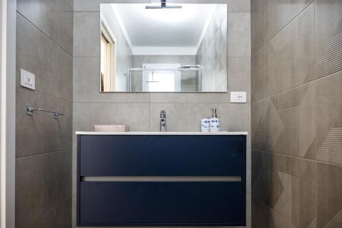 a bathroom with a sink and a mirror at Ad un passo dal mare apartment in Molfetta