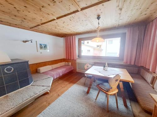a living room with a table and a couch at Berghaus Praxmarer in Längenfeld