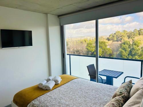 a bedroom with a bed and a large window at Skyline Heaven - Fantastic View - Pool - Garage in Vila Nova de Gaia