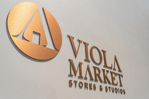 a sign for a wool market stores and suites at FLH Viola Market Flats in Funchal