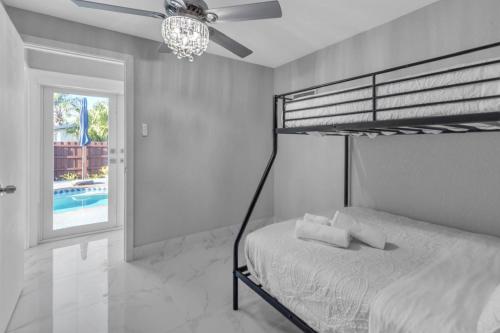 a bedroom with a bunk bed and a ceiling fan at Oasis del Sol in Homestead