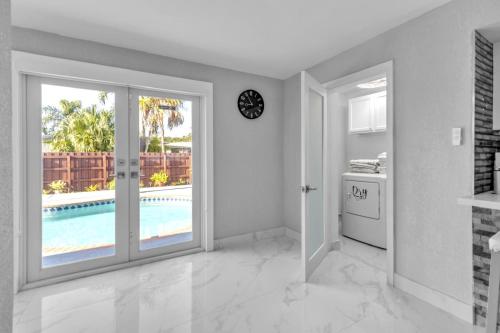 a kitchen with a sliding glass door and a pool at Oasis del Sol in Homestead
