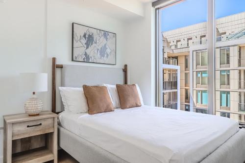 a bedroom with a white bed and a large window at Landing Stunning 2BD Pool Courtyard in Washington