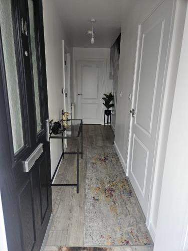 a hallway with a glass table and a door at The Brown Rest House in Gravesend