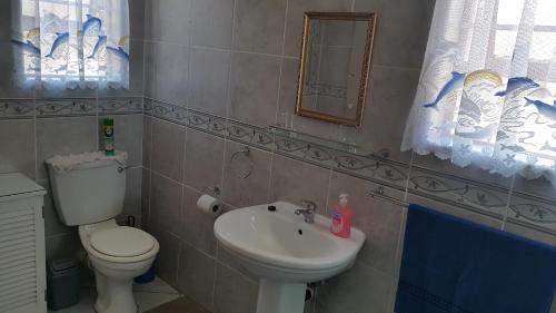 a bathroom with a toilet and a sink at Westcoast Central Budget accommodation in Vredenburg