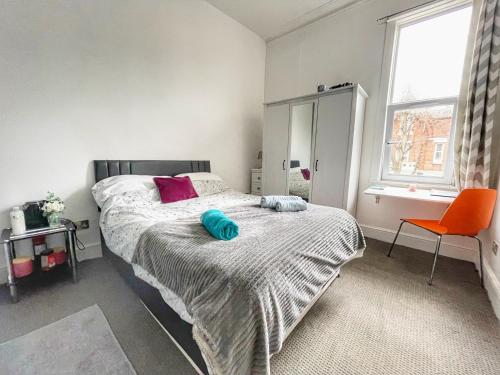 a bedroom with a bed with a blue pillow on it at Central Southsea Studio, Perfect for work or Leisure, Central, Parking, self check-in, modern and comfortable in Portsmouth