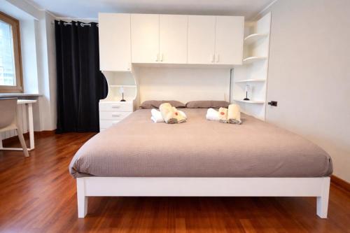 a bedroom with a bed with two pillows on it at Dolomiti Cadore Home in San Pietro di Cadore