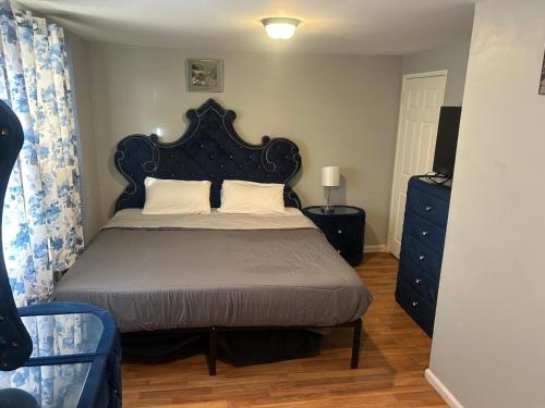 a bedroom with a bed with a black headboard at Grove 3- King Bed with Private Bathroom in Irvington