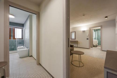 a bathroom with a toilet and a table in a room at Central Guest in Sauze dʼOulx