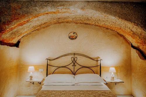 a bedroom with a bed with a stone wall at B&B Lo Gnomo in Pennapiedimonte