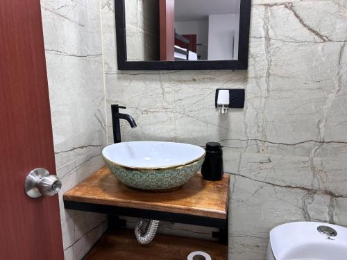 a bathroom with a bowl sink and a mirror at casa lubel in Salento