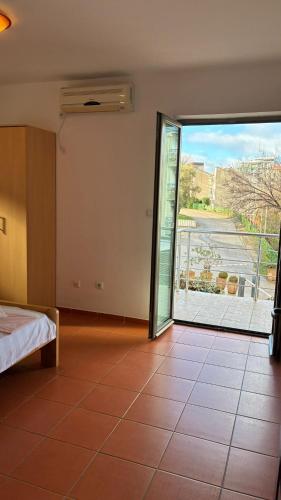a bedroom with a large sliding glass door to a balcony at Apart Ludmila in Bečići
